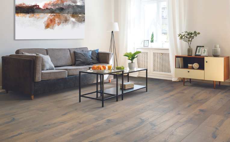 dark wood look laminate in modern living room with black metal coffee table and white media console